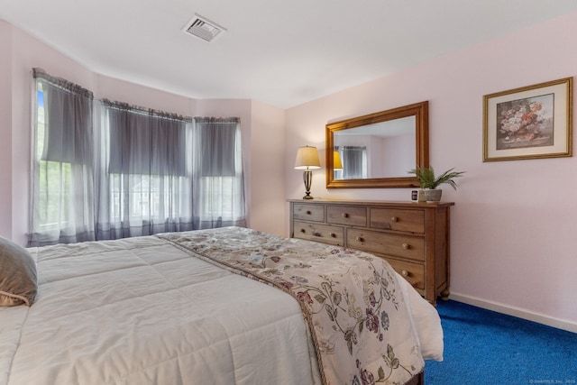 carpeted bedroom featuring baseboards