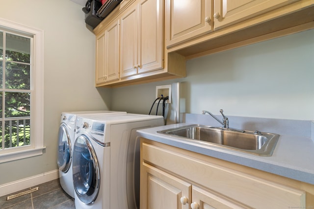 laundry room with cabinet space, washing machine and dryer, plenty of natural light, and baseboards