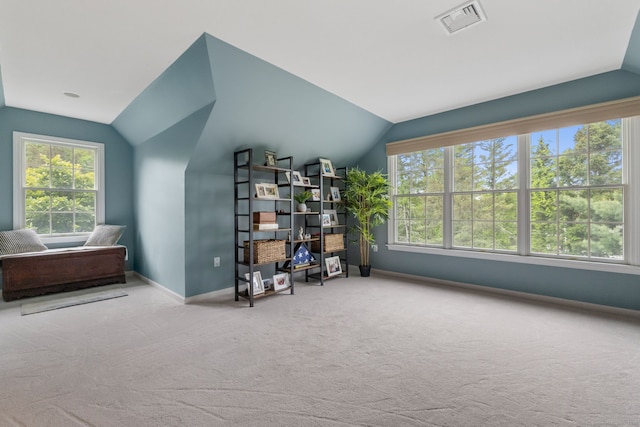 sitting room featuring lofted ceiling, carpet, baseboards, and healthy amount of natural light