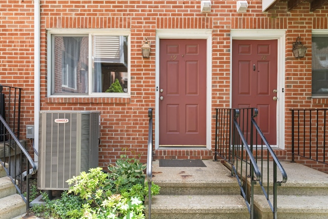 101 Grove St Apt 19, Stamford, CT 06901 - view of exterior entry with brick siding and central AC unit