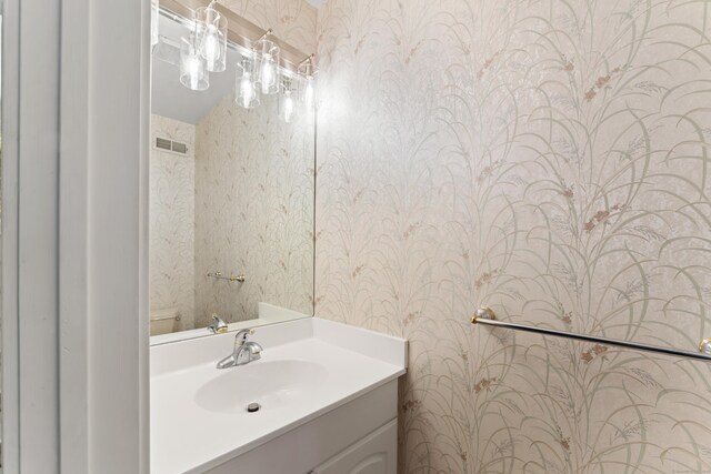 101 Grove St Apt 19, Stamford, CT 06901 - bathroom with wallpapered walls, toilet, and vanity