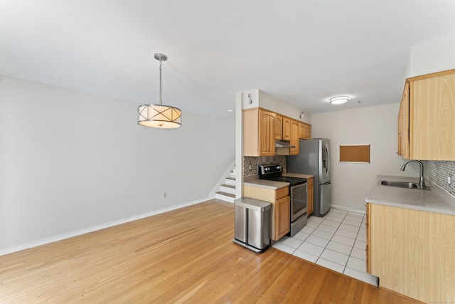 101 Grove St Apt 19, Stamford, CT 06901 - kitchen with stainless steel range with electric stovetop, a sink, backsplash, and under cabinet range hood
