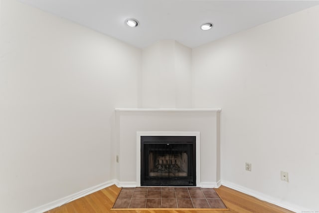 101 Grove St Apt 19, Stamford, CT 06901 - detailed view of wood finished floors, a fireplace with flush hearth, and baseboards