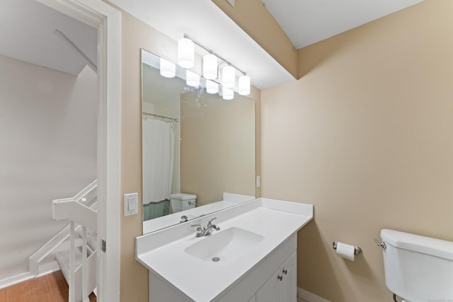 101 Grove St Apt 19, Stamford, CT 06901 - bathroom with toilet, vanity, and baseboards