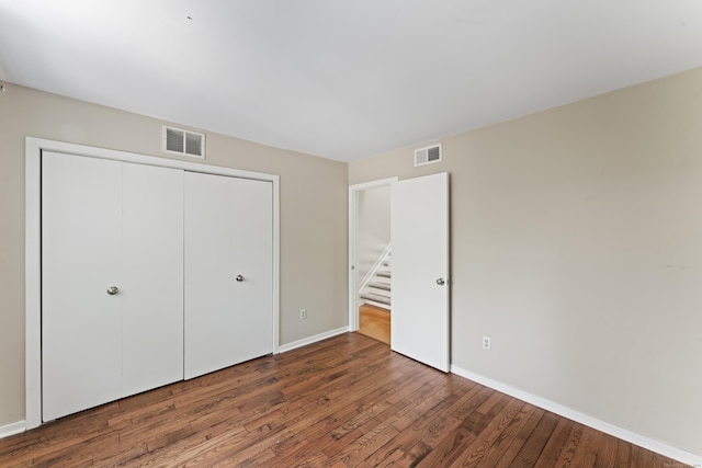 101 Grove St Apt 19, Stamford, CT 06901 - unfurnished bedroom featuring wood finished floors, baseboards, and a closet