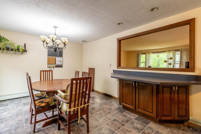 9 Berkshire Dr, East Hampton, CT 06424 - dining area with stone finish floors, a chandelier, a textured ceiling, and baseboards