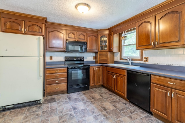 9 Berkshire Dr, East Hampton, CT 06424 - kitchen featuring black appliances, a sink, brown cabinets, a textured ceiling, and dark countertops