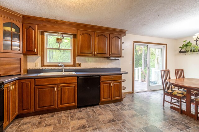 9 Berkshire Dr, East Hampton, CT 06424 - kitchen featuring black dishwasher, a sink, brown cabinetry, dark countertops, and backsplash