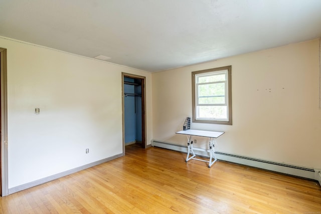 9 Berkshire Dr, East Hampton, CT 06424 - unfurnished bedroom with a baseboard heating unit, light wood finished floors, baseboards, and a closet