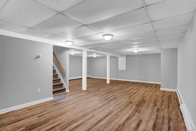 6 Marbil Rd, Danbury, CT 06811 - finished below grade area with baseboard heating, wood finished floors, a drop ceiling, baseboards, and stairway