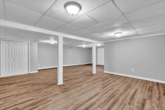 6 Marbil Rd, Danbury, CT 06811 - finished below grade area featuring a paneled ceiling, wood finished floors, baseboard heating, baseboards, and a baseboard radiator