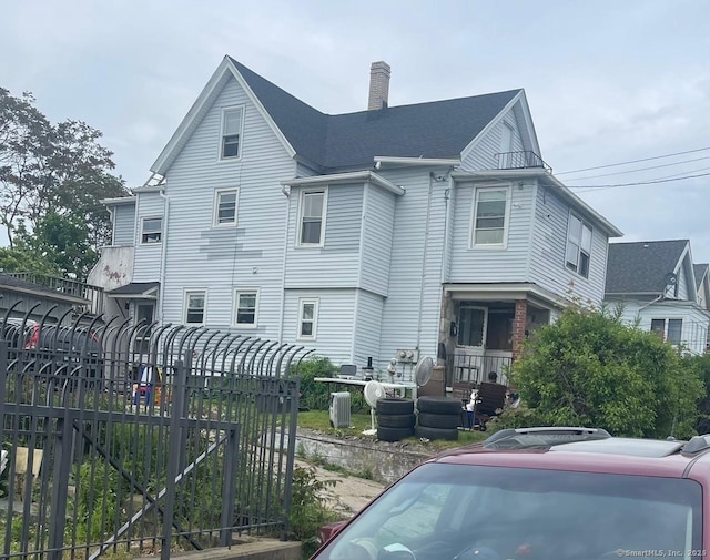 92 Alice St, Bridgeport, CT 06606 - view of property exterior featuring a chimney, fence, central air condition unit, and a gate