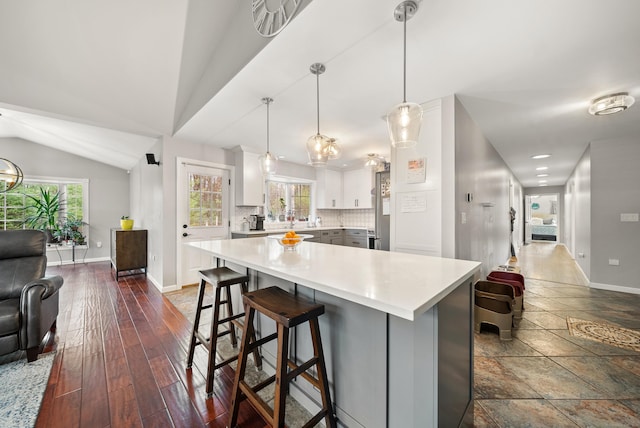 108 Lohse Rd, Willington, CT 06279 - kitchen featuring light countertops, open floor plan, baseboards, tasteful backsplash, and a kitchen breakfast bar