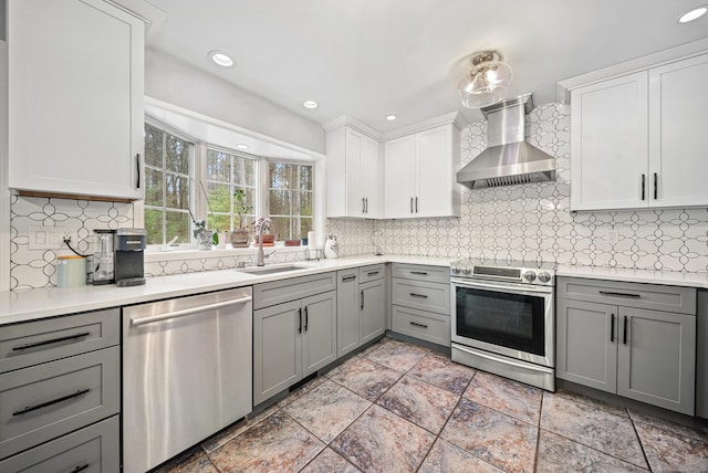 108 Lohse Rd, Willington, CT 06279 - kitchen featuring stainless steel appliances, wall chimney exhaust hood, gray cabinets, a sink, and light countertops