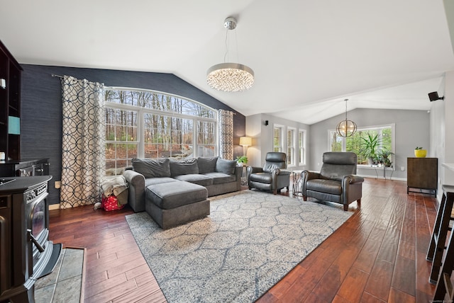 108 Lohse Rd, Willington, CT 06279 - living room featuring a chandelier, vaulted ceiling, plenty of natural light, dark wood-type flooring, and a wood stove