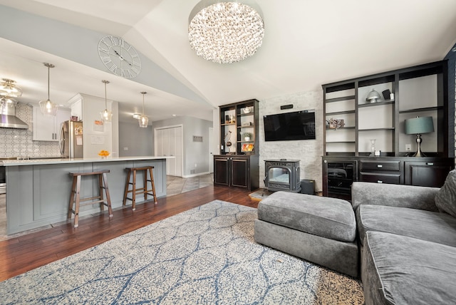 108 Lohse Rd, Willington, CT 06279 - living room featuring dark wood-style floors, lofted ceiling, a chandelier, baseboards, and a wood stove