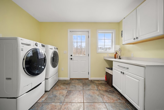 108 Lohse Rd, Willington, CT 06279 - laundry area featuring washer and dryer, cabinet space, baseboards, and light stone finish floors