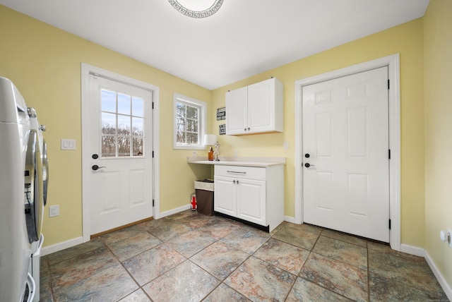 108 Lohse Rd, Willington, CT 06279 - laundry room with cabinet space, baseboards, stone tile flooring, and washing machine and dryer