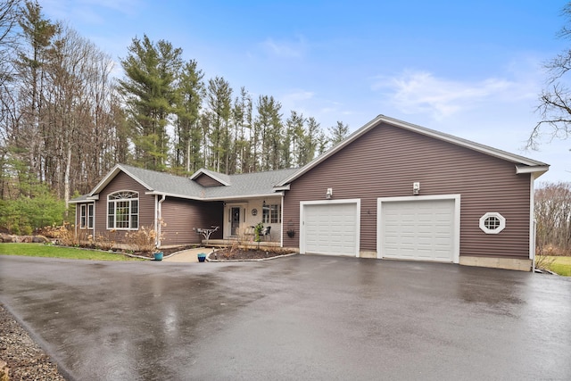 108 Lohse Rd, Willington, CT 06279 - single story home with asphalt driveway, an attached garage, and a shingled roof