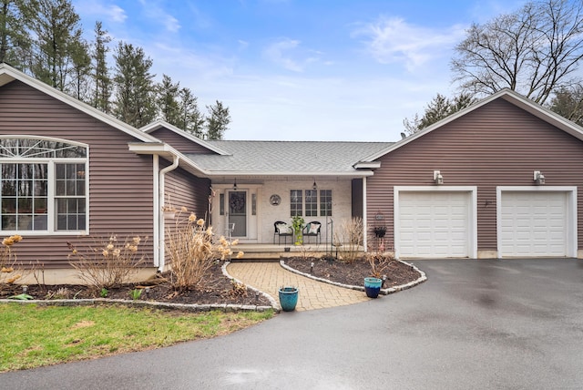 108 Lohse Rd, Willington, CT 06279 - single story home with driveway, covered porch, a garage, and roof with shingles
