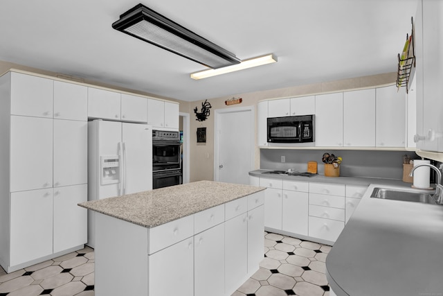 1 Nod Brook Dr, Simsbury, CT 06070 - kitchen featuring black appliances, a sink, light floors, and a kitchen island