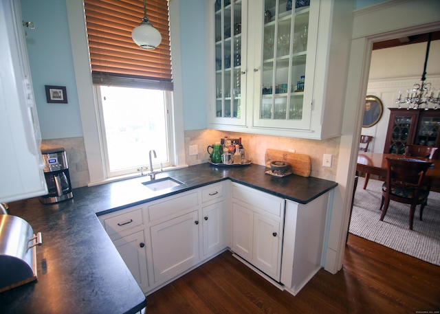 27 Church St, Groton, CT 06340 - kitchen with dark countertops, white cabinetry, glass insert cabinets, and backsplash