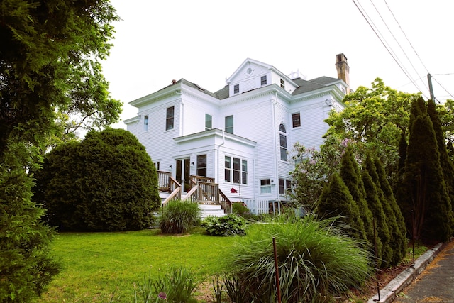 27 Church St, Groton, CT 06340 - view of front of property with a chimney, a front lawn, and a wooden deck