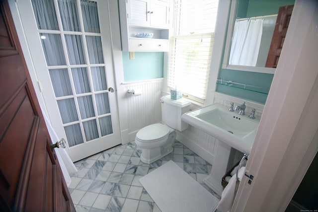 27 Church St, Groton, CT 06340 - bathroom with a wainscoted wall, marble look tile flooring, and a shower with curtain