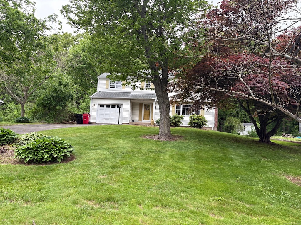 85 Elmwood Dr, Meriden, CT 06450 - view of front of house with driveway, a front yard, and an attached garage