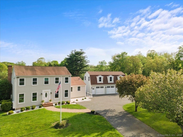 299 W Flat Hill Rd, Southbury, CT 06488 - view of front facade with a chimney, a front yard, and a garage