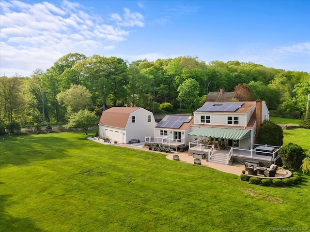 299 W Flat Hill Rd, Southbury, CT 06488 - rear view of property with a deck, a yard, roof mounted solar panels, and a patio