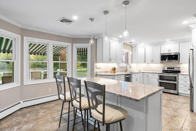 299 W Flat Hill Rd, Southbury, CT 06488 - kitchen with stainless steel appliances, a sink, a breakfast bar area, light stone counters, and white cabinetry