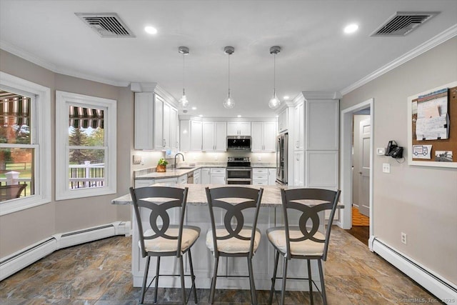 299 W Flat Hill Rd, Southbury, CT 06488 - kitchen featuring a baseboard radiator, stainless steel appliances, stone finish flooring, a breakfast bar area, and crown molding