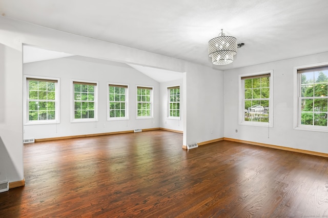 unfurnished room featuring dark wood-style flooring, baseboards, a chandelier, and vaulted ceiling