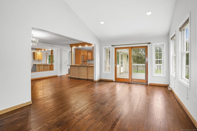 unfurnished living room with dark wood-style floors, baseboards, recessed lighting, and high vaulted ceiling