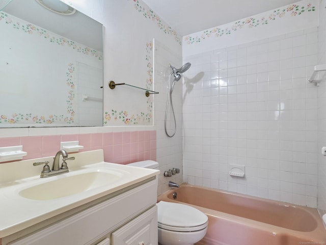 bathroom with vanity, toilet, bathing tub / shower combination, and wallpapered walls