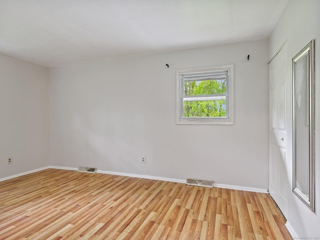 unfurnished bedroom featuring light wood-type flooring and baseboards