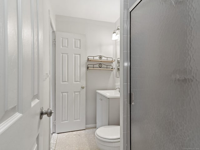 full bath with tile patterned flooring, a shower stall, vanity, and toilet