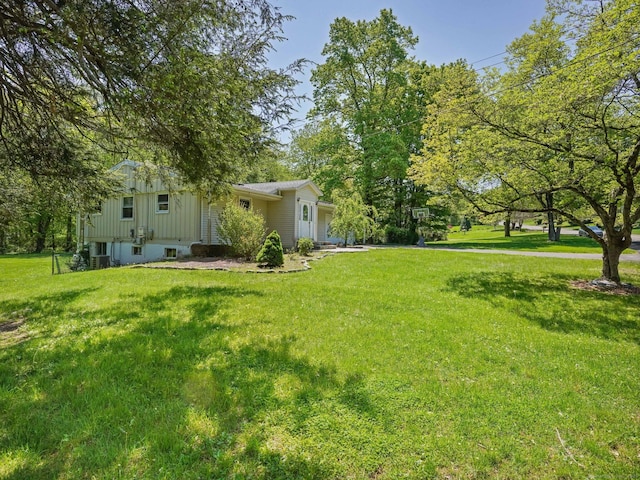 view of grassy yard with an attached garage