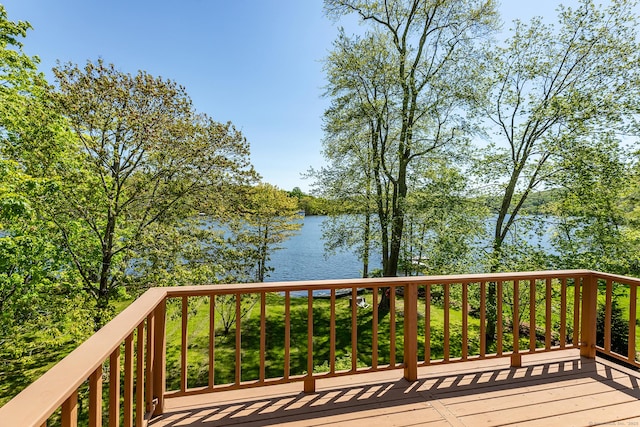 wooden terrace featuring a water view
