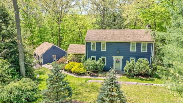 12 Sandy Ln, Marlborough, CT 06447 - colonial inspired home featuring a chimney, a front yard, and a wooded view