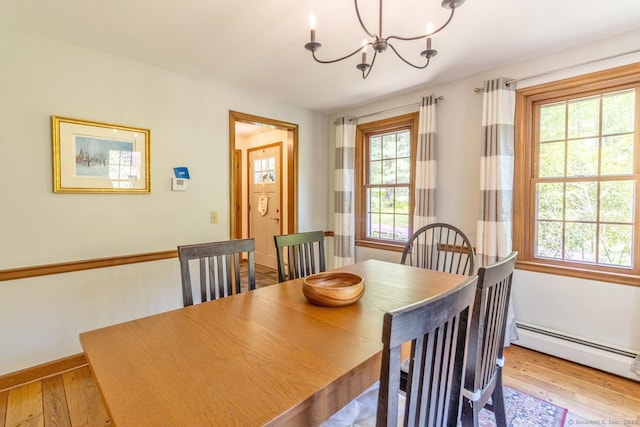 12 Sandy Ln, Marlborough, CT 06447 - dining space featuring a chandelier, wood finished floors, a baseboard radiator, and baseboards