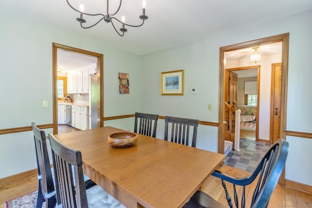 12 Sandy Ln, Marlborough, CT 06447 - dining space featuring a chandelier, baseboards, and light wood-style flooring
