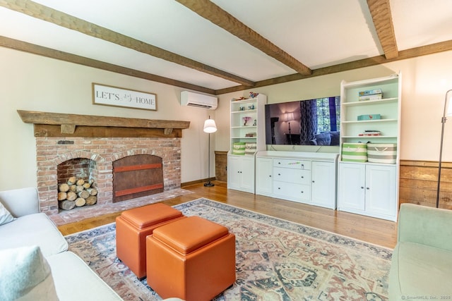 12 Sandy Ln, Marlborough, CT 06447 - living room with a wall unit AC, wood finished floors, beamed ceiling, and a brick fireplace