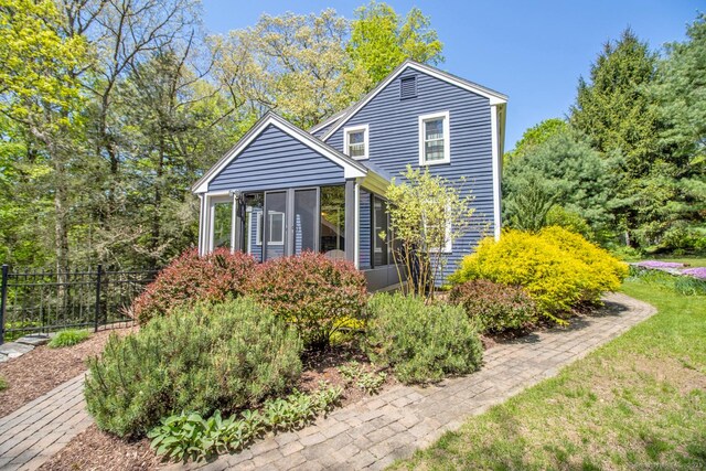 12 Sandy Ln, Marlborough, CT 06447 - view of side of home featuring a sunroom and fence