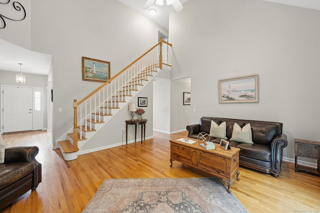 107 Chestnut Hill Rd Unit 107, Portland, CT 06480 - living area with stairway, wood finished floors, a high ceiling, a ceiling fan, and baseboards