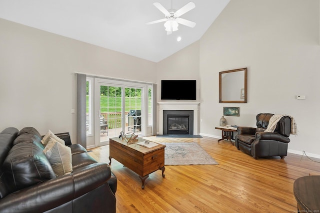 107 Chestnut Hill Rd Unit 107, Portland, CT 06480 - living room with high vaulted ceiling, light wood-style flooring, ceiling fan, baseboards, and a fireplace with flush hearth