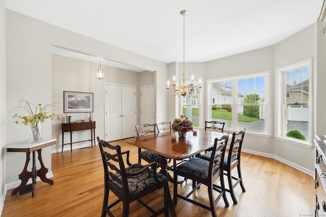 107 Chestnut Hill Rd Unit 107, Portland, CT 06480 - dining room with light wood finished floors, a chandelier, and baseboards