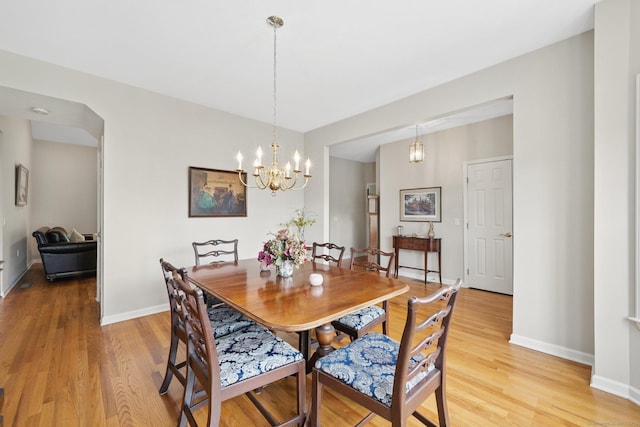 107 Chestnut Hill Rd Unit 107, Portland, CT 06480 - dining room featuring light wood-type flooring, baseboards, and a chandelier