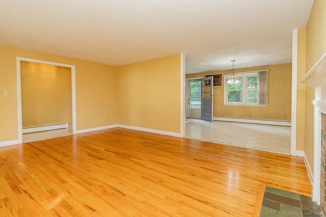 123 Jeffrey Ln, Newington, CT 06111 - spare room with baseboard heating, wood finished floors, a chandelier, and baseboards